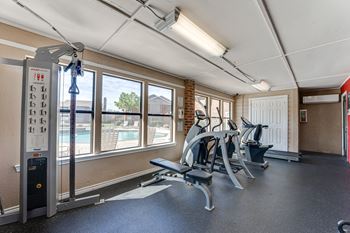 Fitness center with strength training equipment and pool view